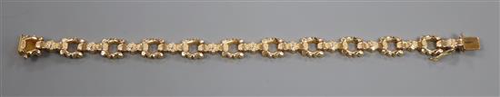 An Italian 750 yellow metal fancy link bracelet with flower spacers, 12.4g, 18.3cm.